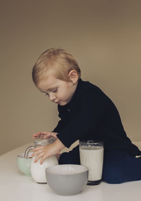 little boy taking milk jar 1